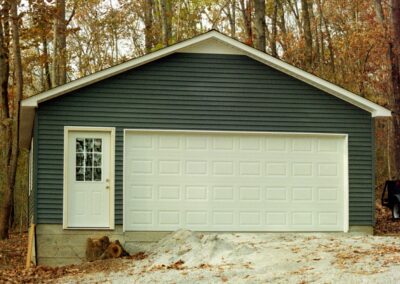 Single garage door with one walkthrough door by MasterCraft Construction