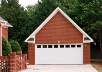 Single garage door with one walkthrough door by MasterCraft Construction