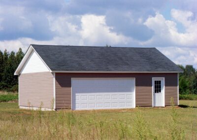 Single garage door with one walkthrough door by MasterCraft Construction