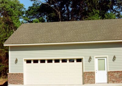 Single garage door with one walkthrough door by MasterCraft Construction
