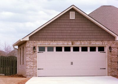 Single garage door with one walkthrough door by MasterCraft Construction