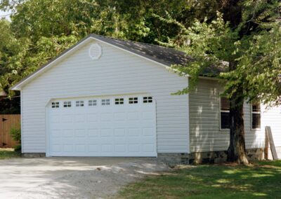 Single garage door with one walkthrough door by MasterCraft Construction