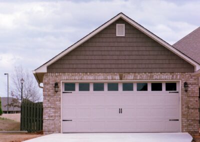 Single garage door with one walkthrough door by MasterCraft Construction