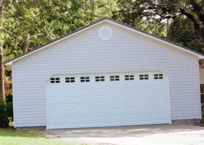 Single garage door with one walkthrough door by MasterCraft Construction