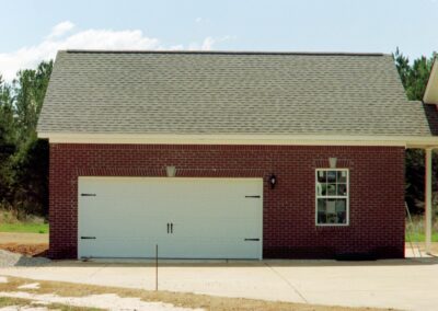 Single garage door with one walkthrough door by MasterCraft Construction