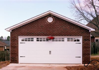 Single garage door with one walkthrough door by MasterCraft Construction