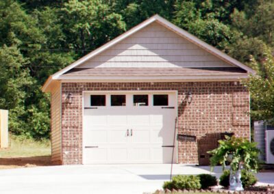 Single garage door with one walkthrough door by MasterCraft Construction