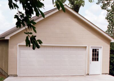Single garage door with one walkthrough door by MasterCraft Construction