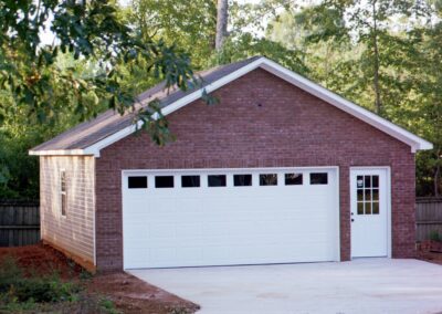 Single garage door with one walkthrough door by MasterCraft Construction